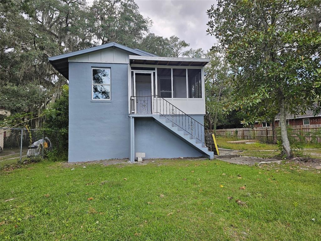 a view of a house with a yard and sitting area