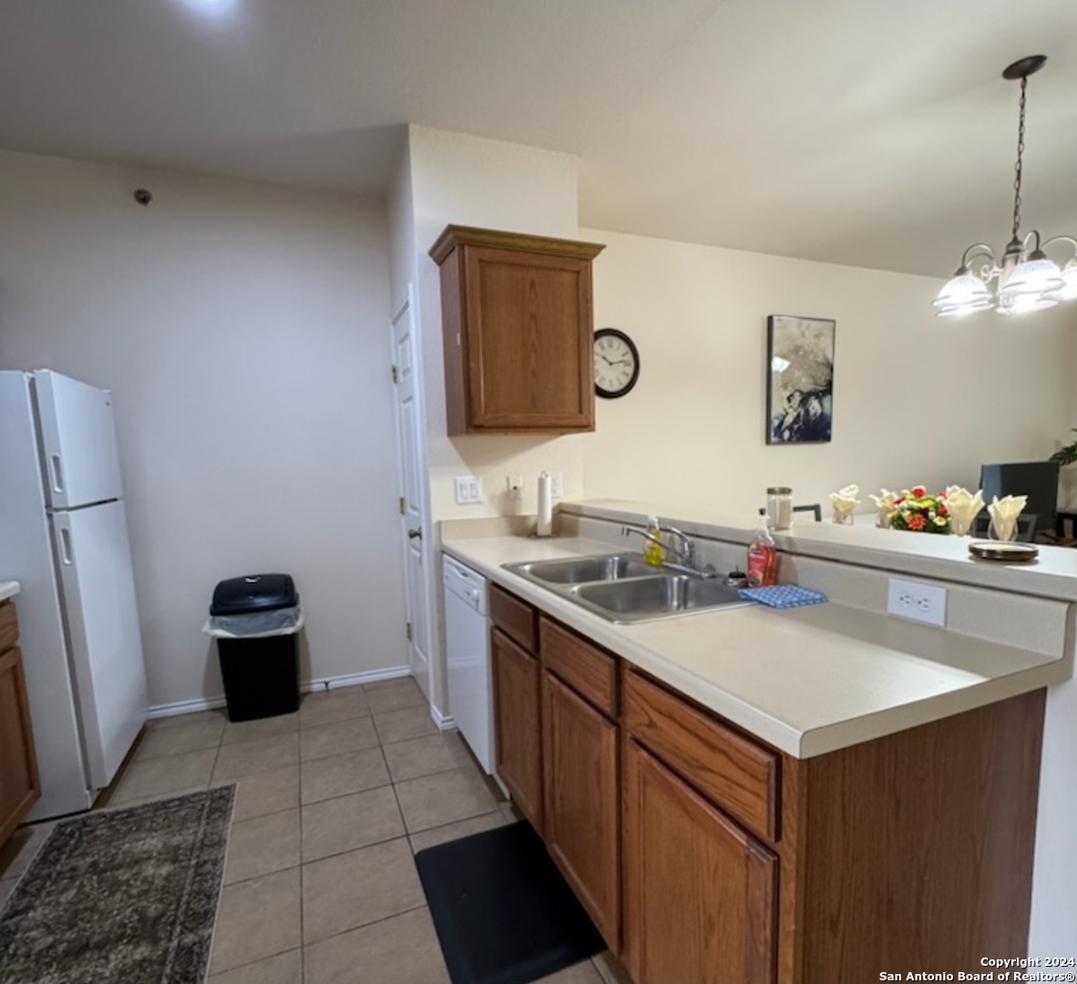 a kitchen with a sink cabinets and a refrigerator