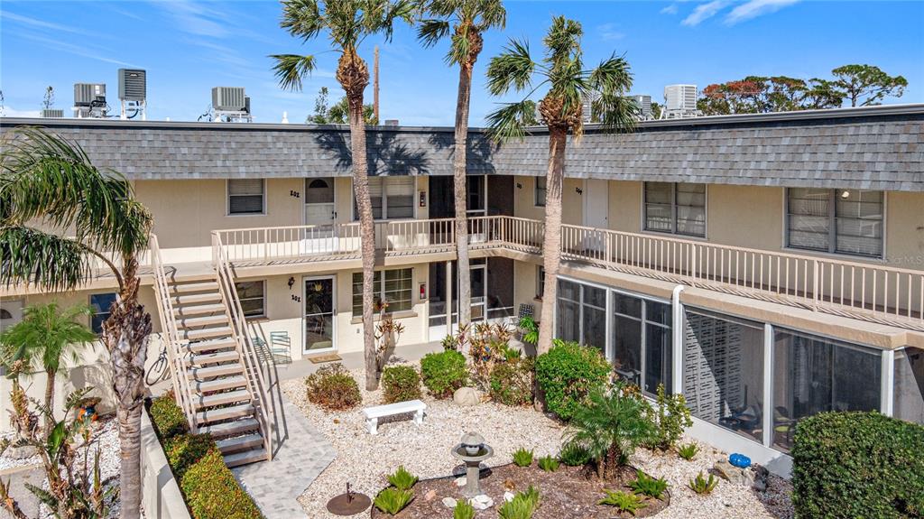 aerial view of a house with a yard and potted plants