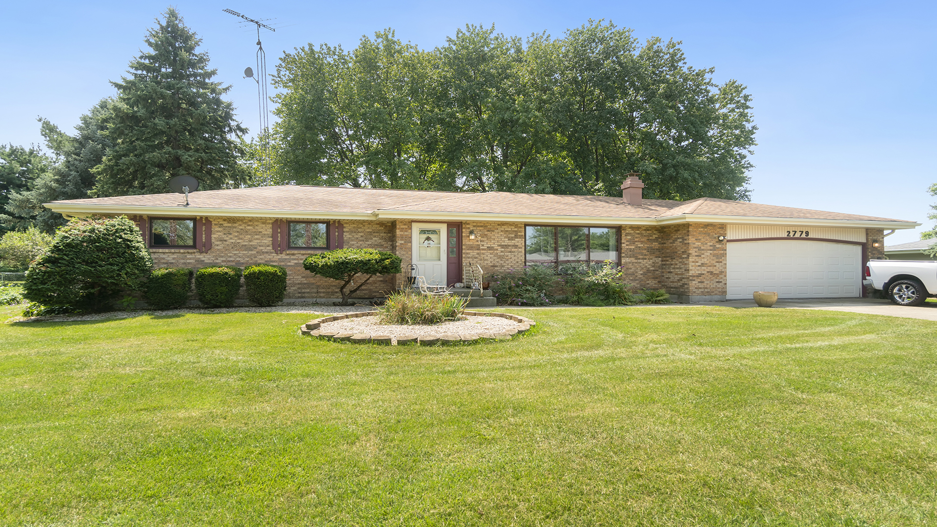 a front view of a house with yard and green space