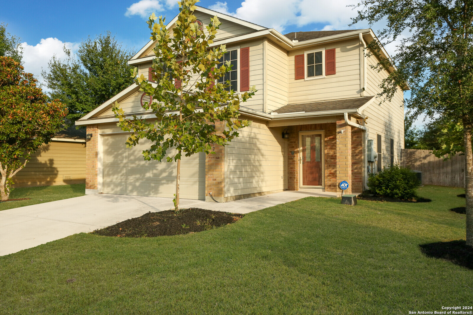 a front view of a house with a yard