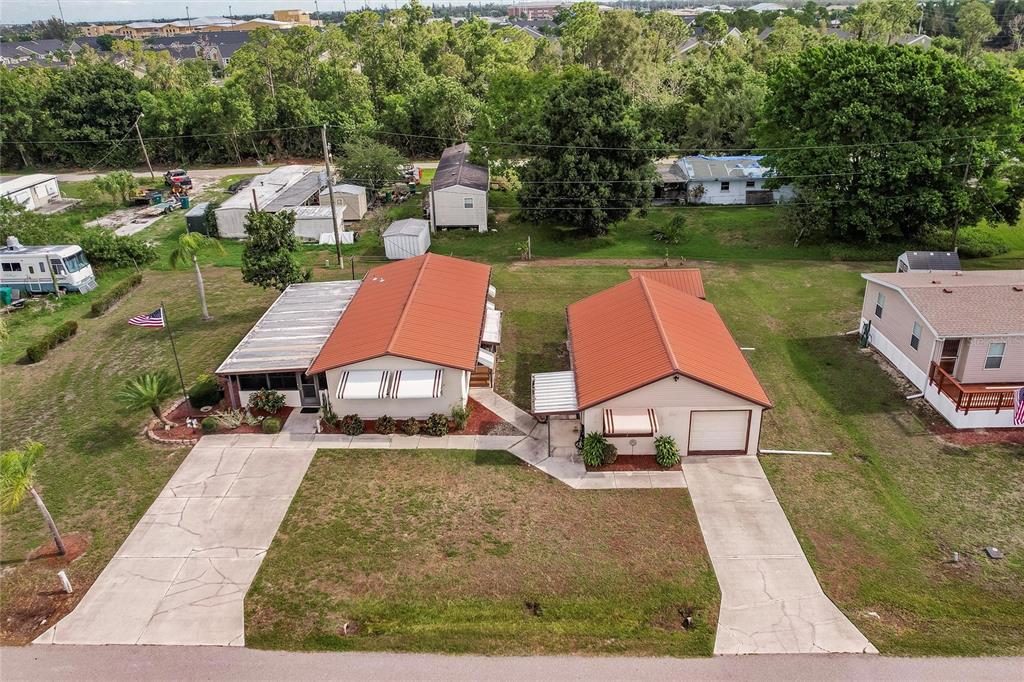 an aerial view of a house with swimming pool and sitting area