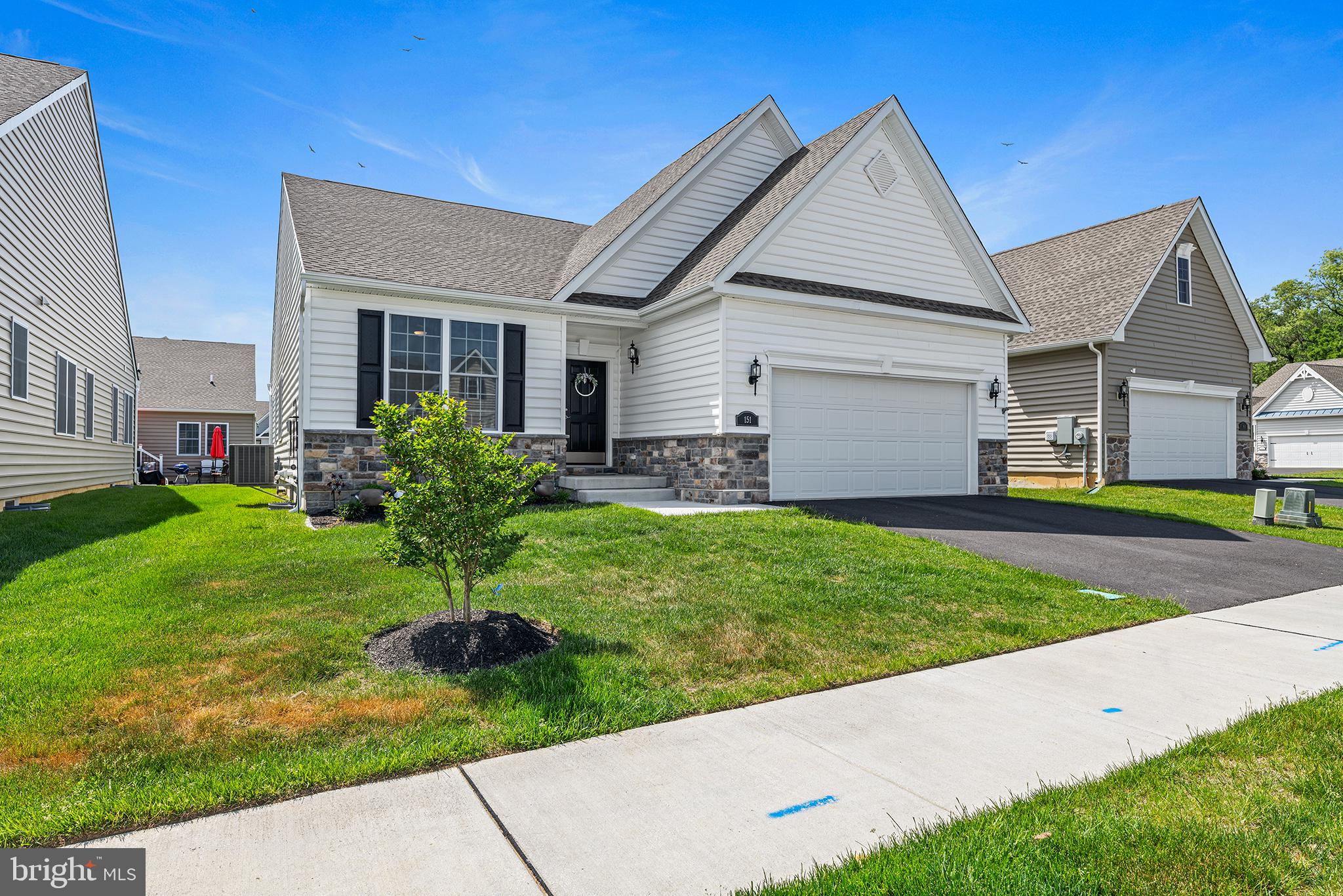 a front view of house with yard and green space