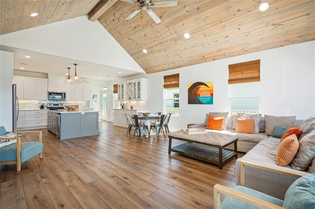 a living room with furniture and kitchen view