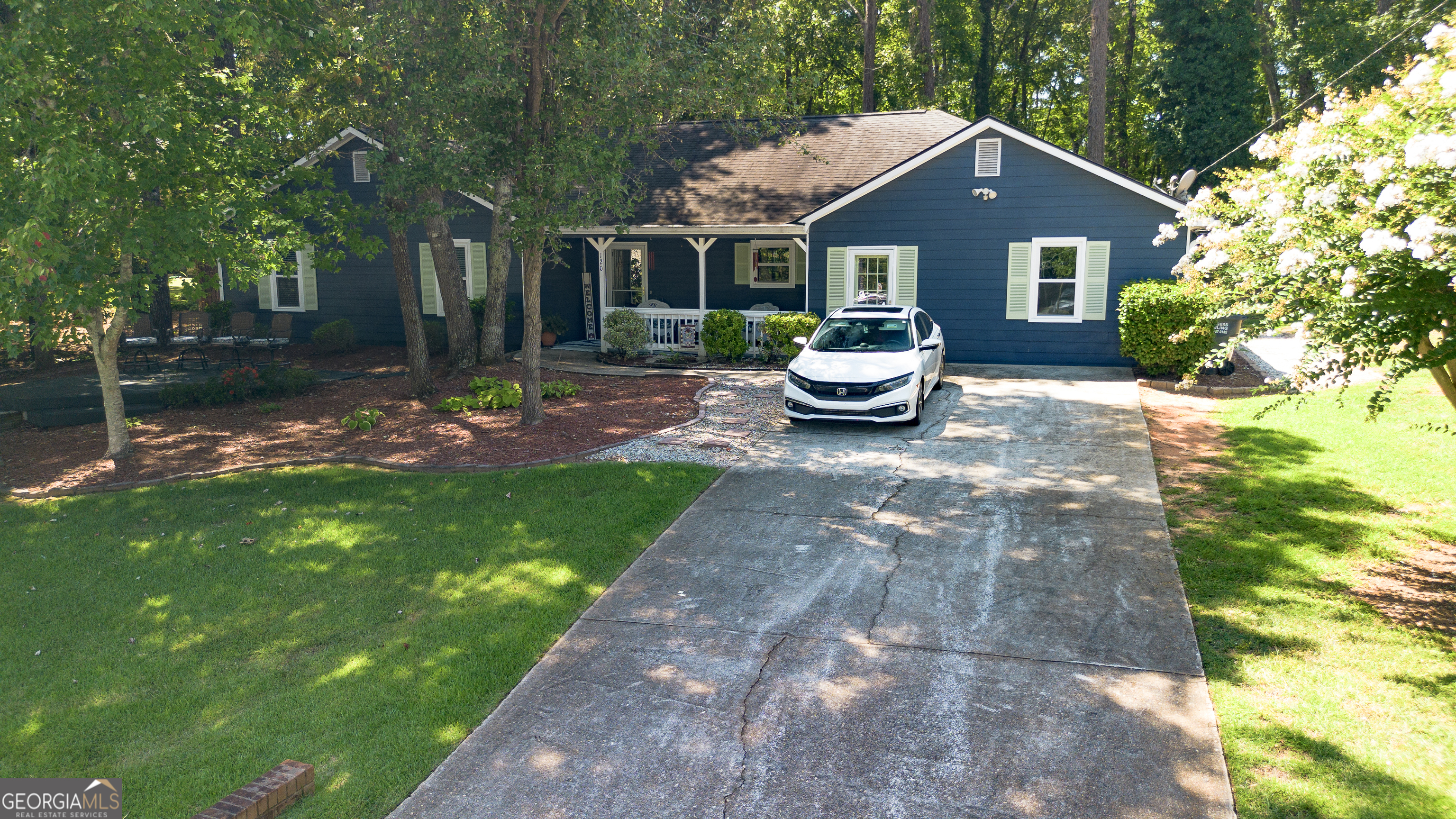 a front view of a house with garden