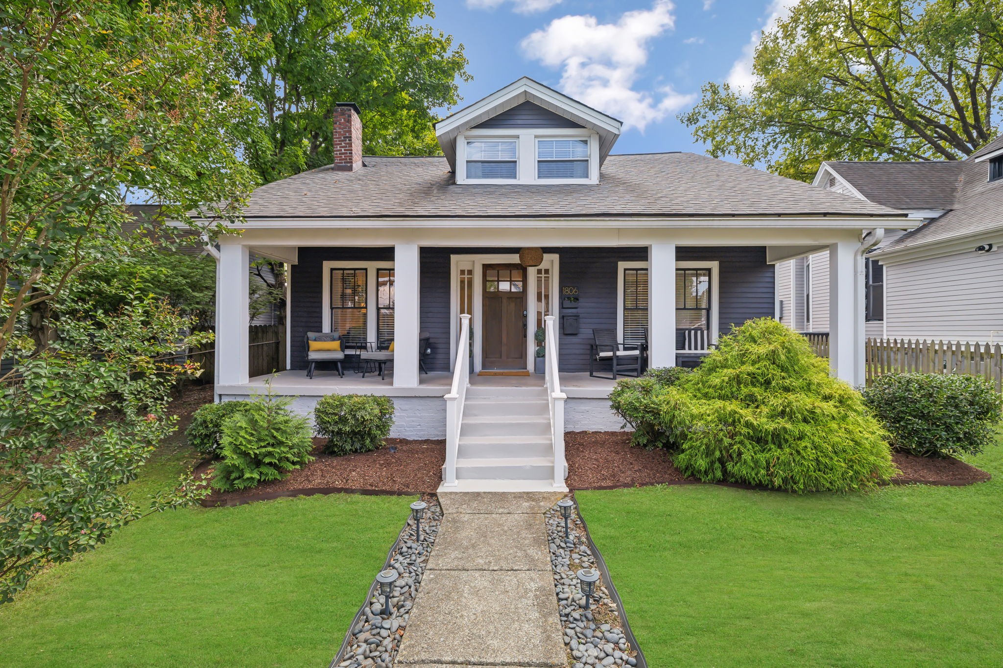 a front view of a house with garden