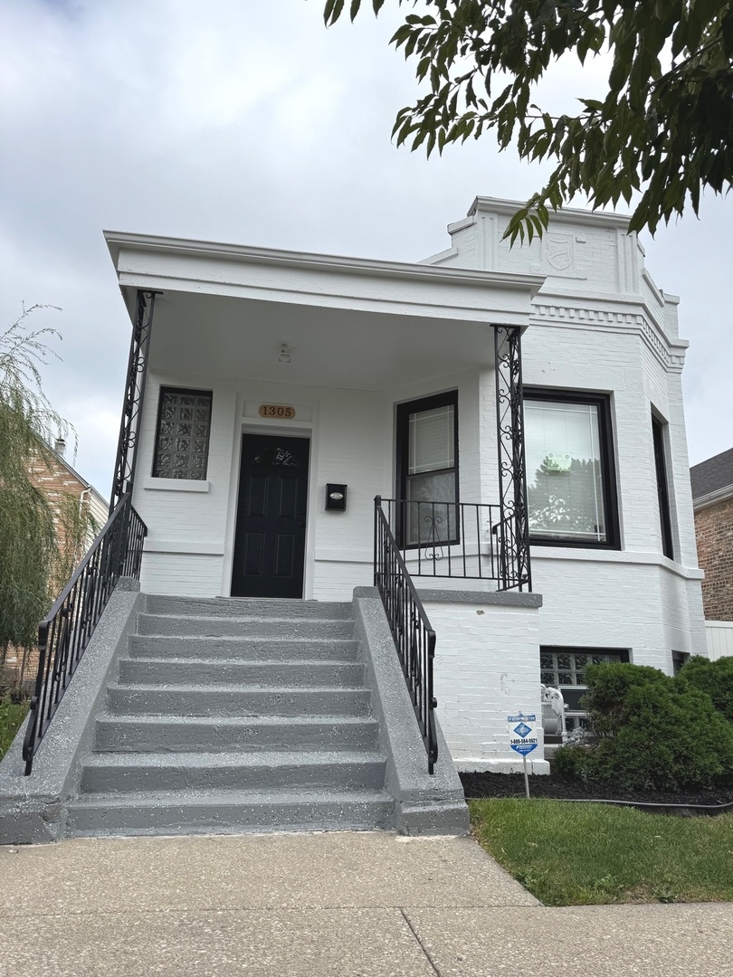 a front view of a house with entryway and windows