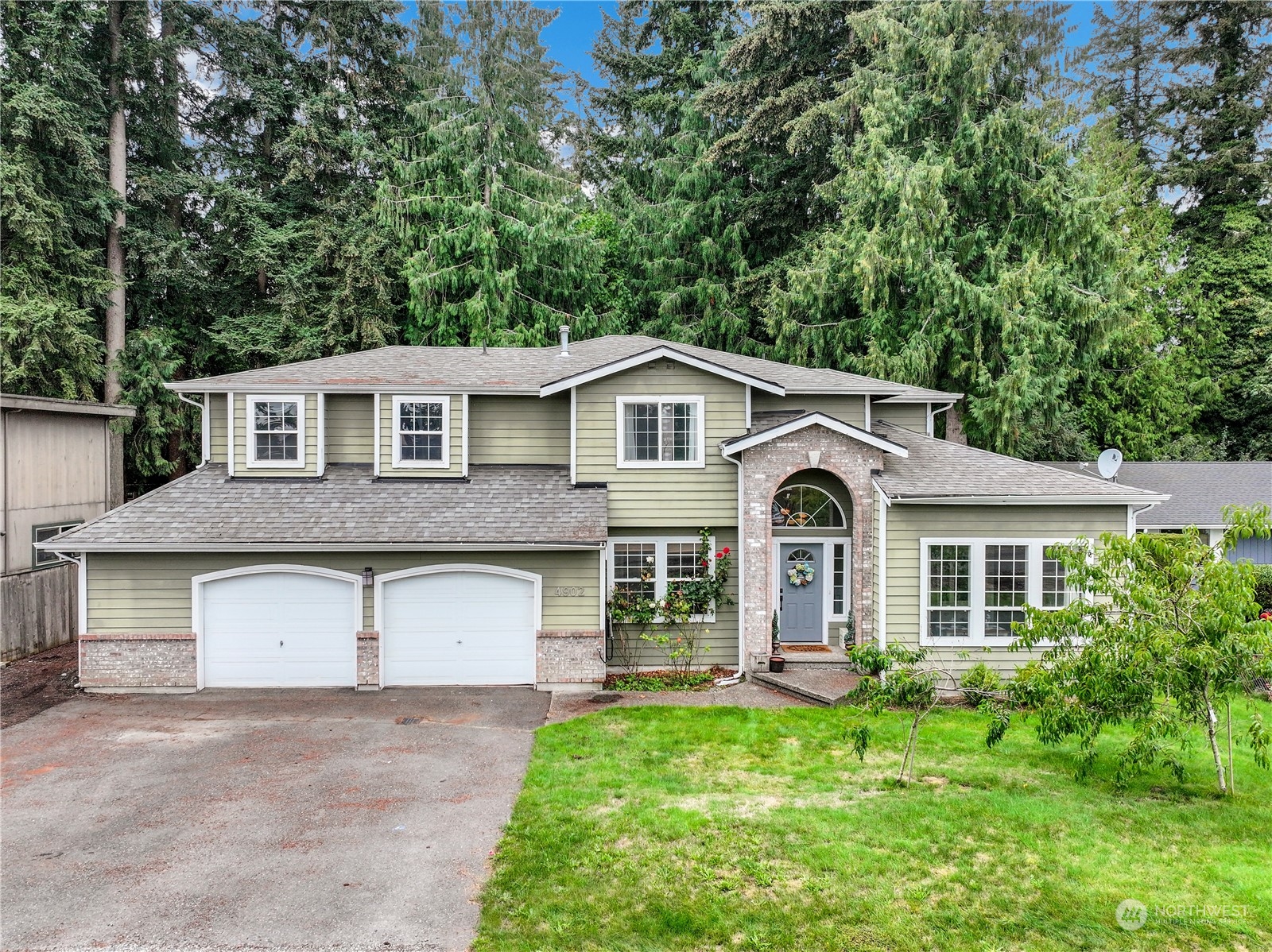 a front view of a house with a yard and garage