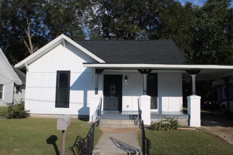 a front view of a house with garden