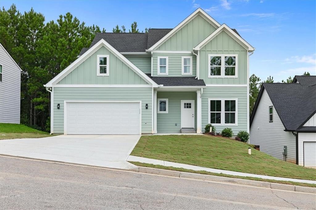 a front view of a house with a yard and garage