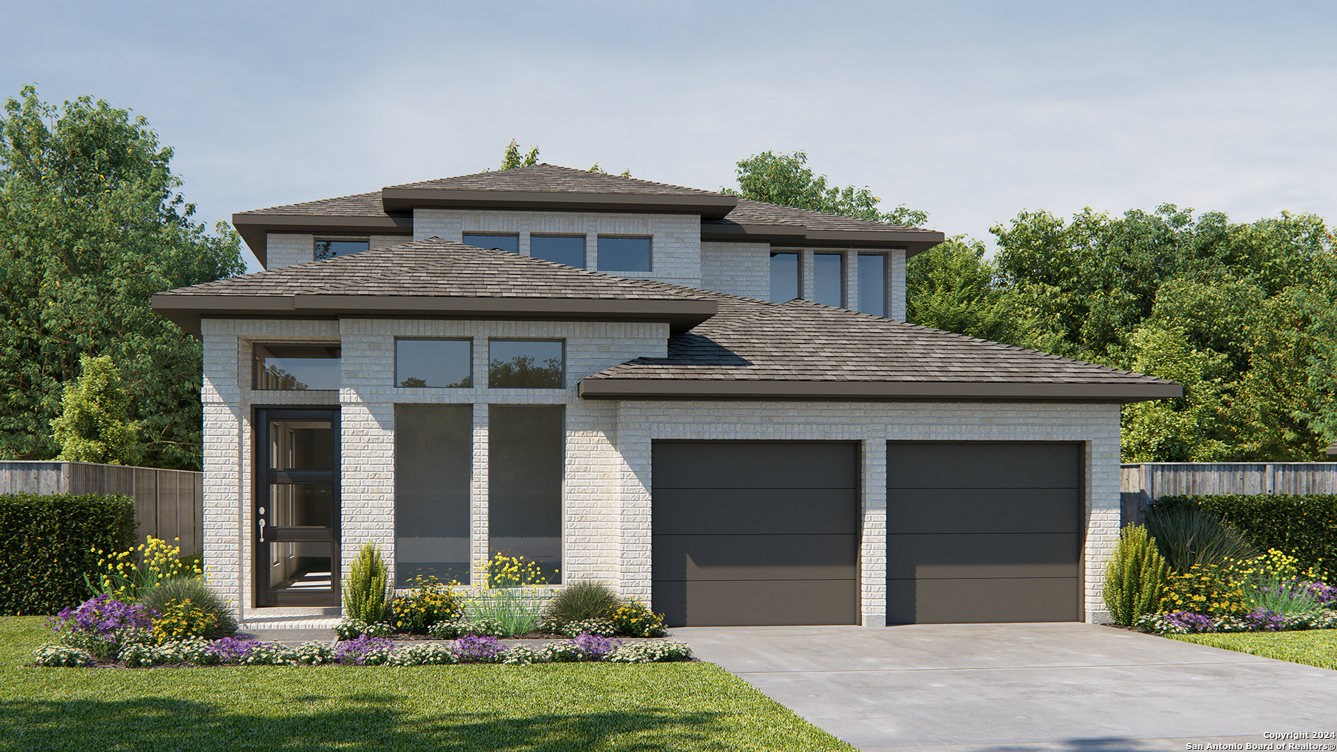 a front view of a house with a yard and garage