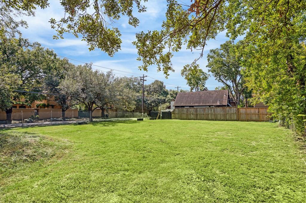 a view of a big yard with a fountain