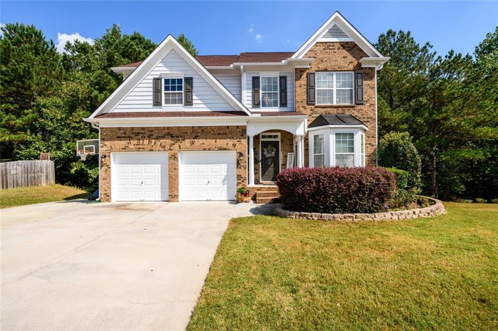 a front view of a house with a yard