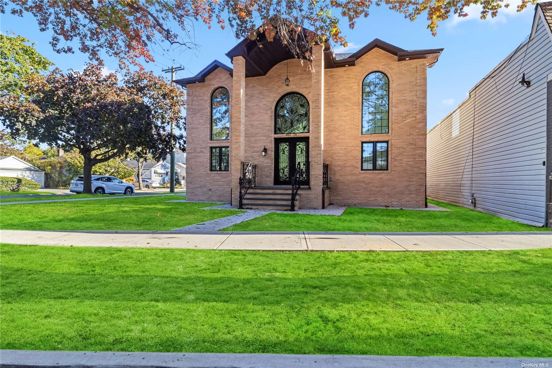 a front view of a house with a garden and yard