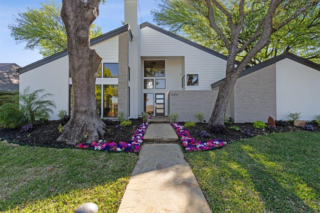 a view of a house with a yard and garden