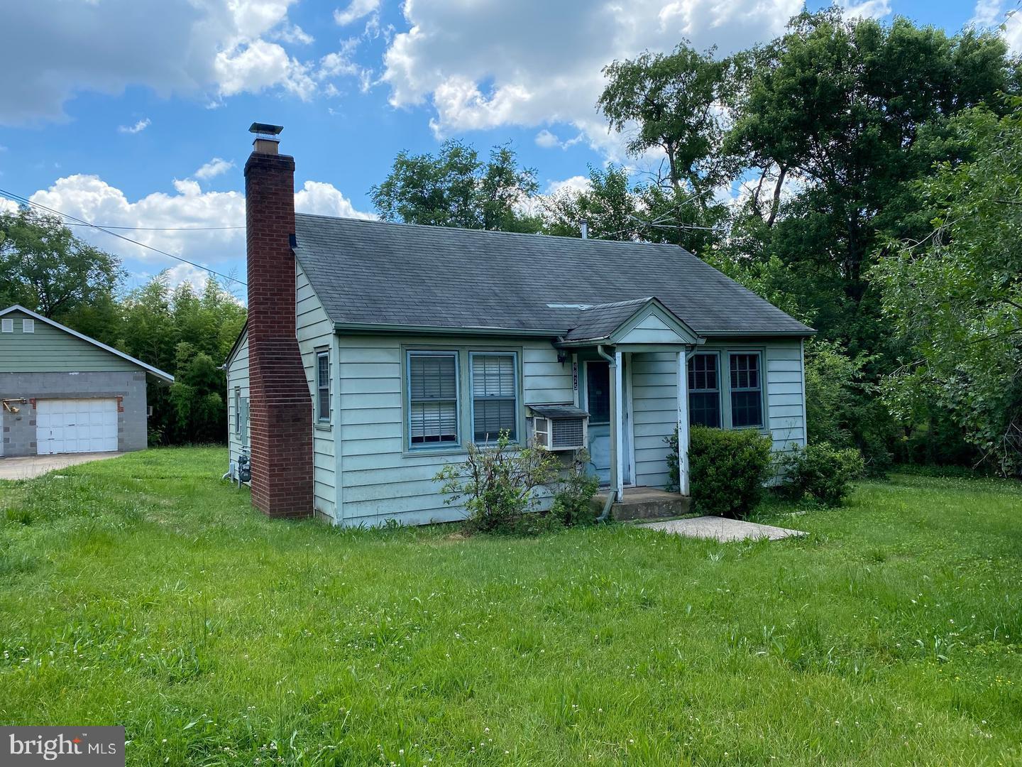 a front view of a house with a garden and yard