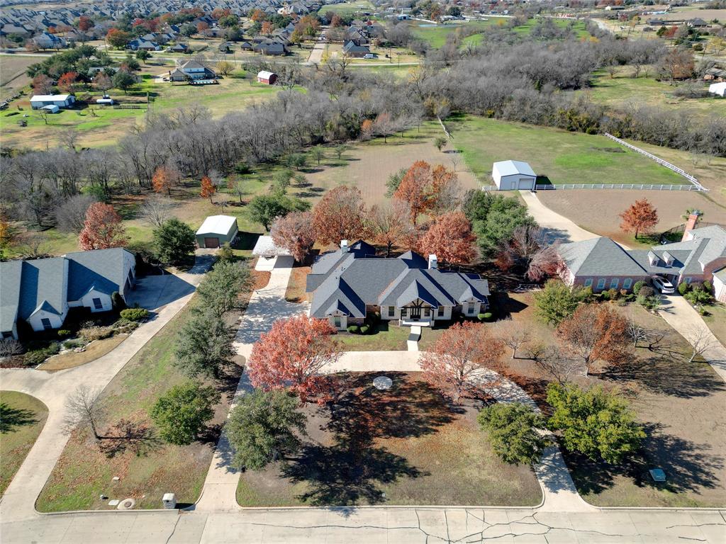 an aerial view of a house with garden space and ocean view