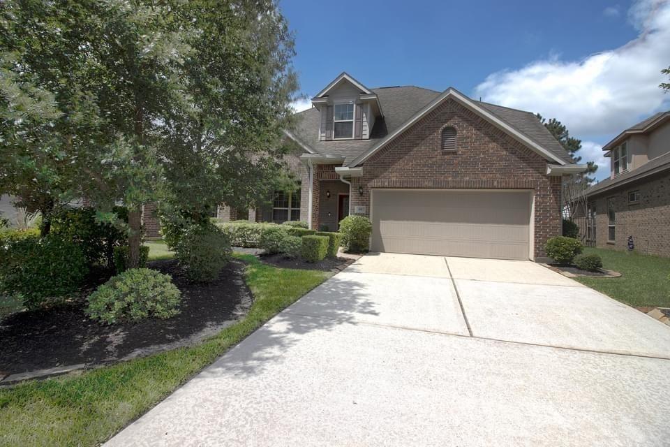 a front view of a house with a yard and a garage