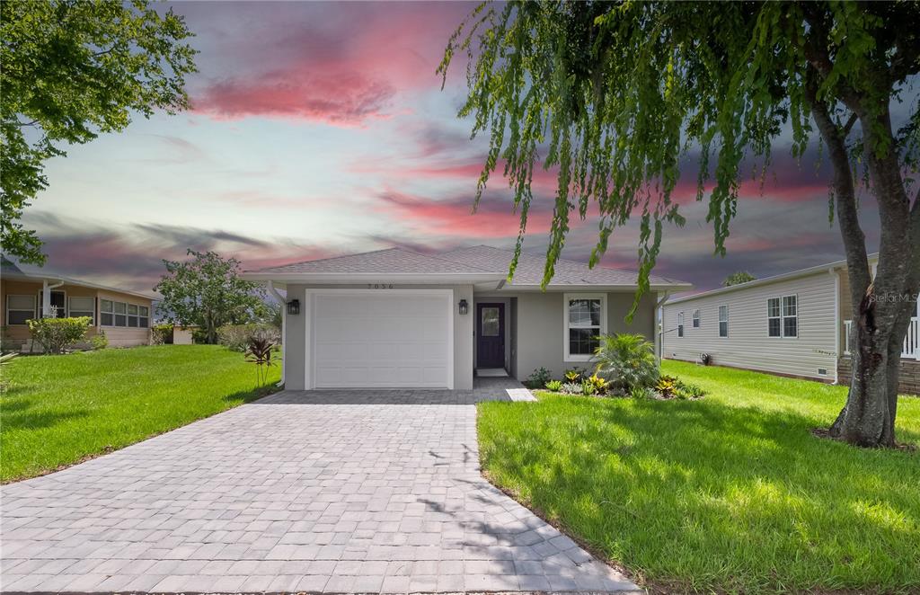 a front view of house with yard and green space