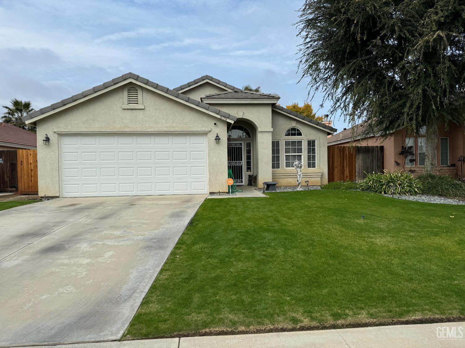 a front view of house with yard and green space