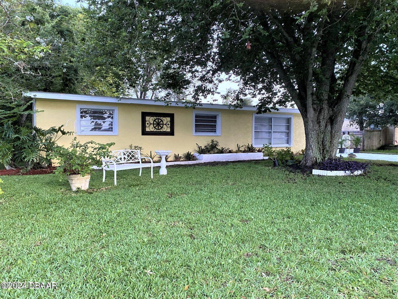 a front view of house with yard and seating area