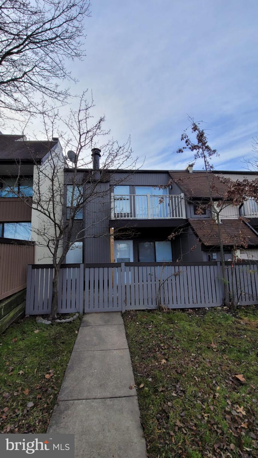 a view of a house with wooden fence