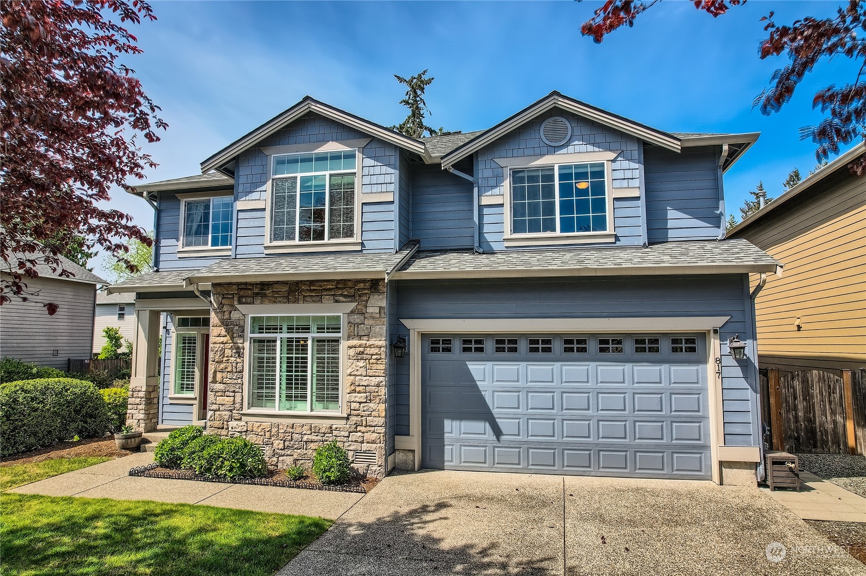 a front view of a house with a yard and garage