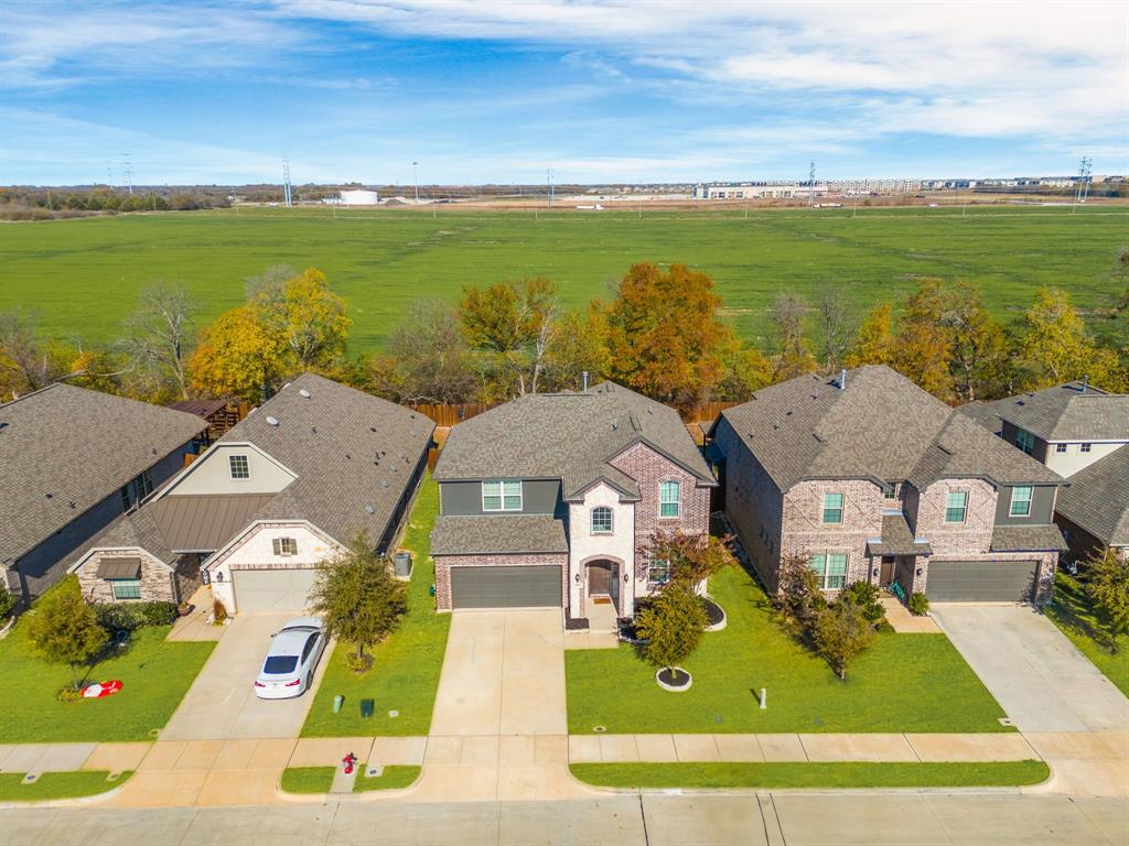 an aerial view of residential houses with outdoor space and ocean view