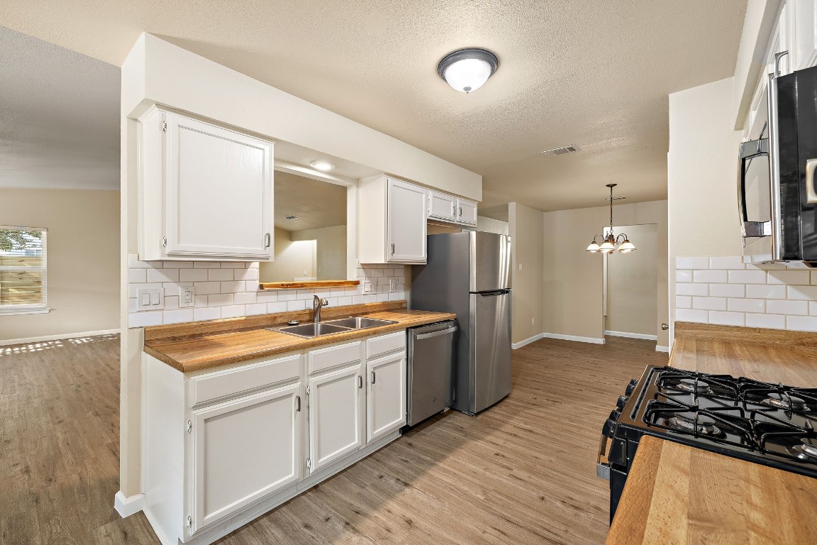 a kitchen with a sink stove and refrigerator