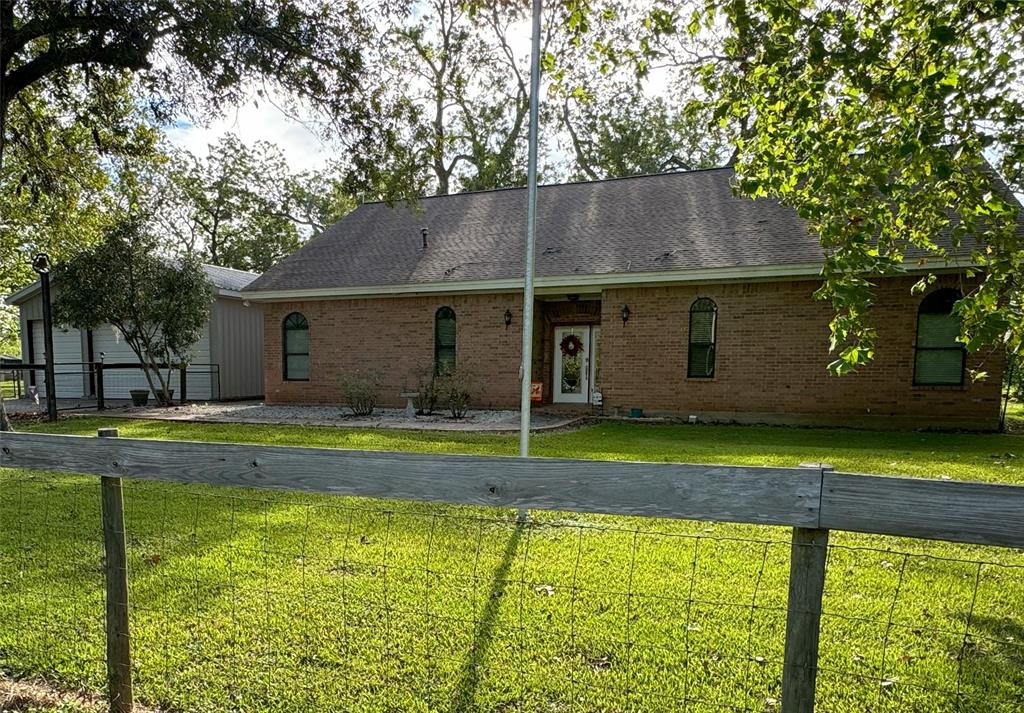 a view of a house with pool and a yard