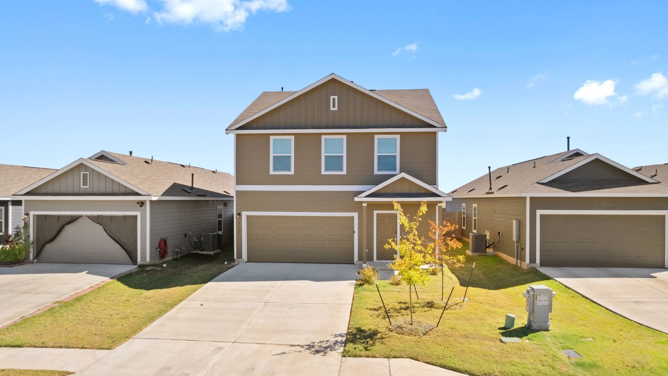 a front view of a house with a yard and garage