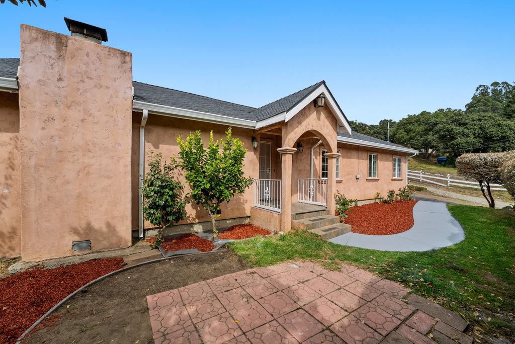 a front view of a house with garden