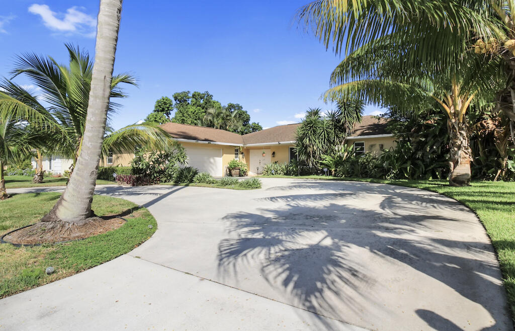 a front view of a house with a yard and a garage