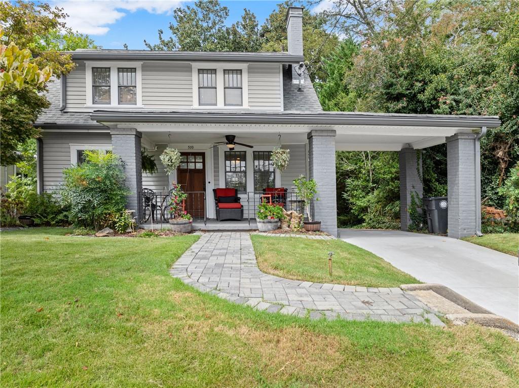 a view of a house with backyard porch and sitting area