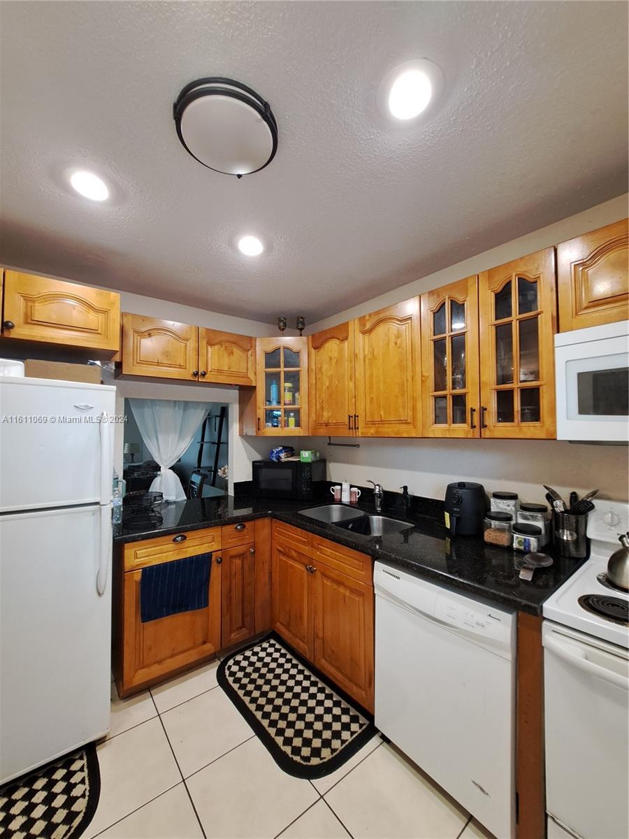 a kitchen with stainless steel appliances granite countertop a stove sink and cabinets