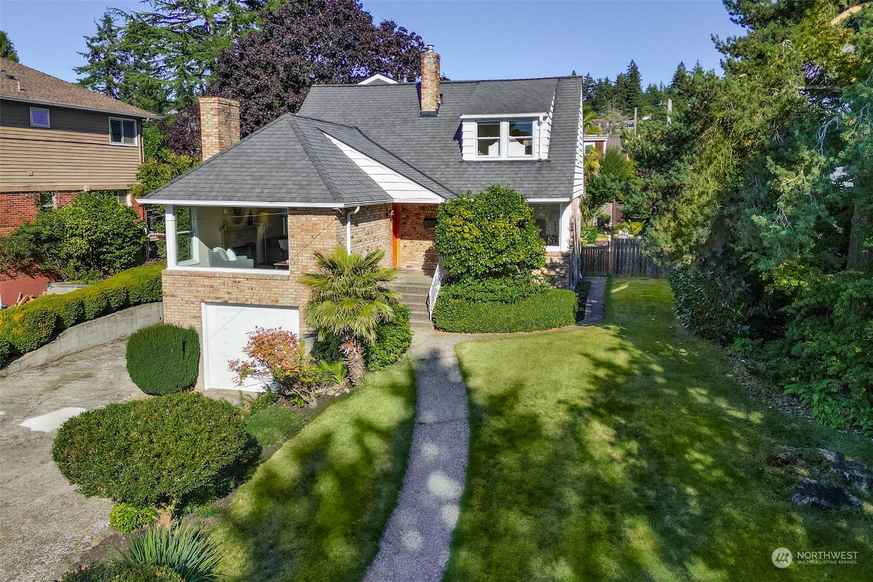 a view of a house with a yard and plants