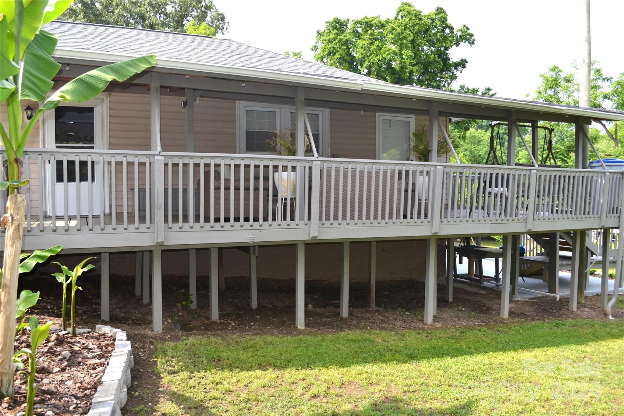 a view of a house with a yard and sitting area