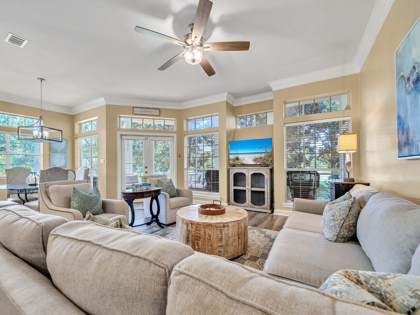 a living room with furniture and large windows