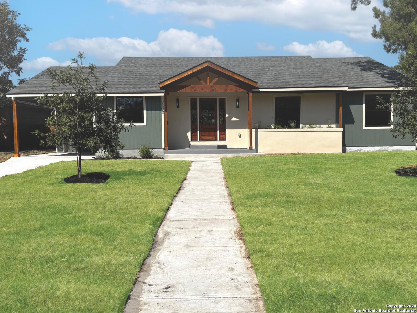 a front view of a house with a yard