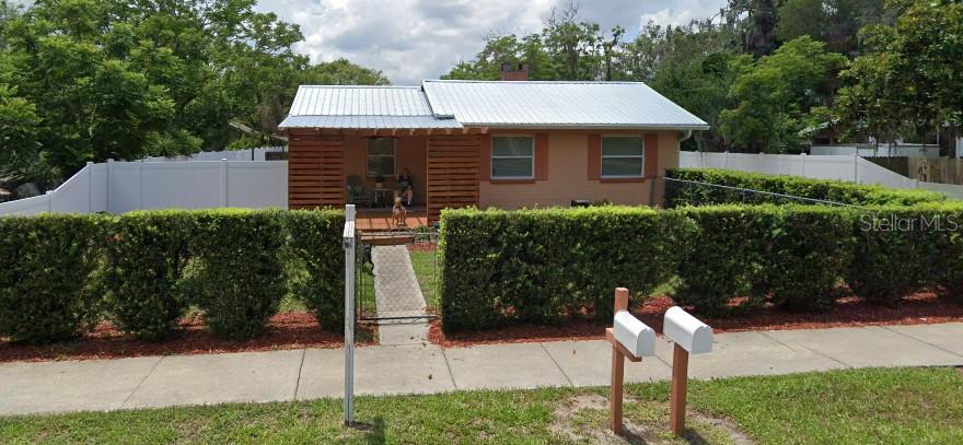 a front view of a house with garden