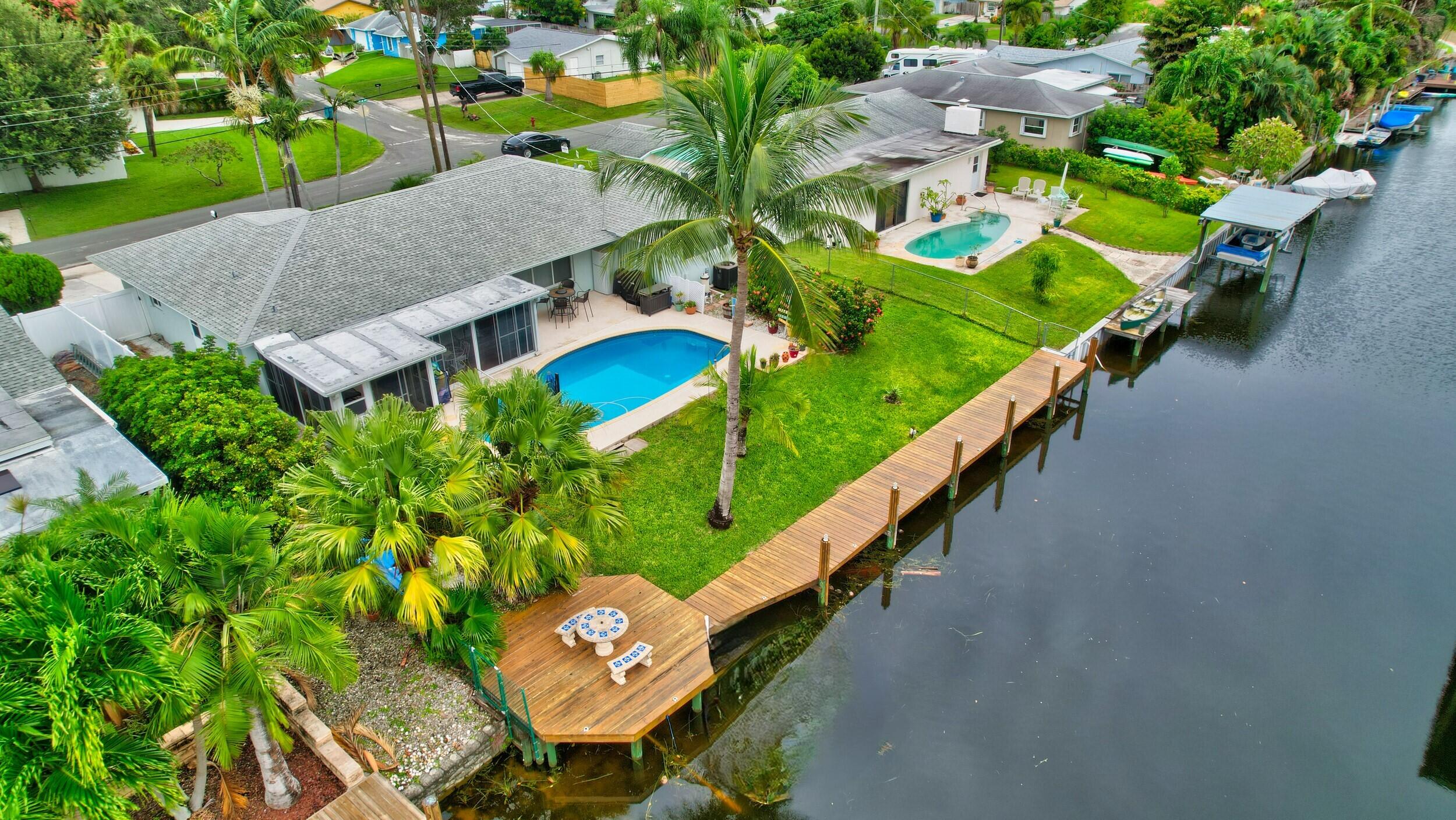 an aerial view of a house with garden space and street view