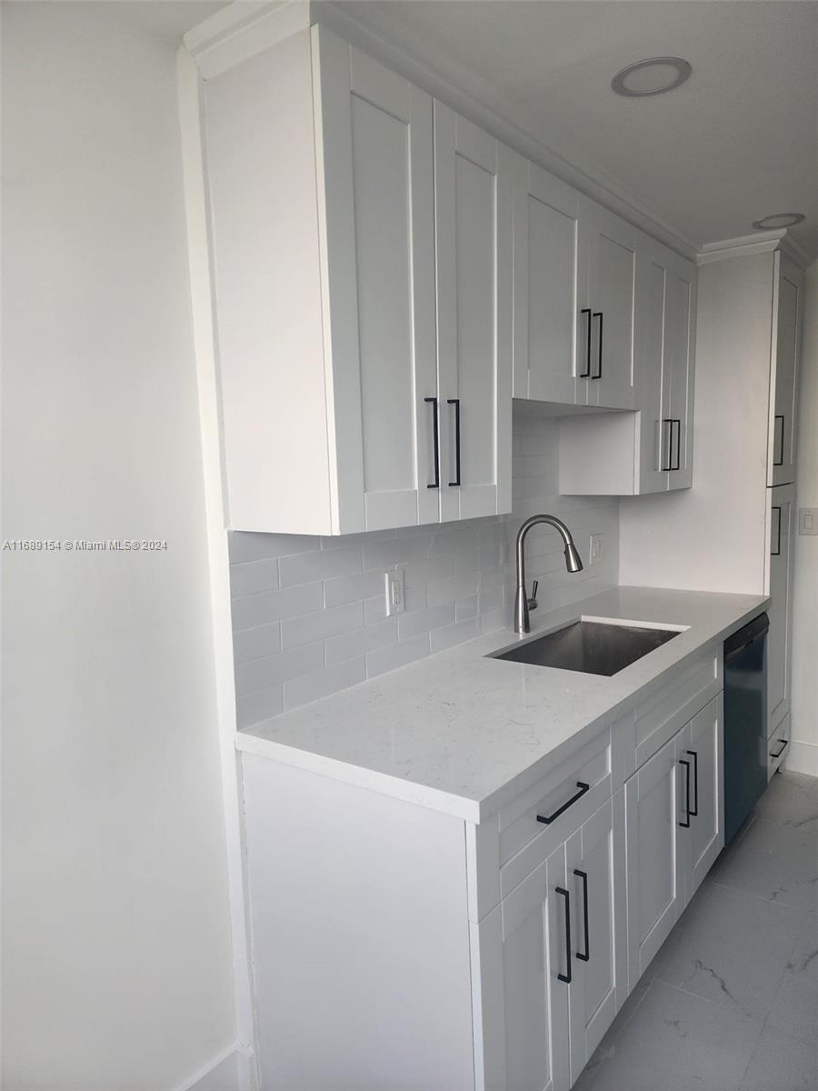 a kitchen with a sink and cabinets