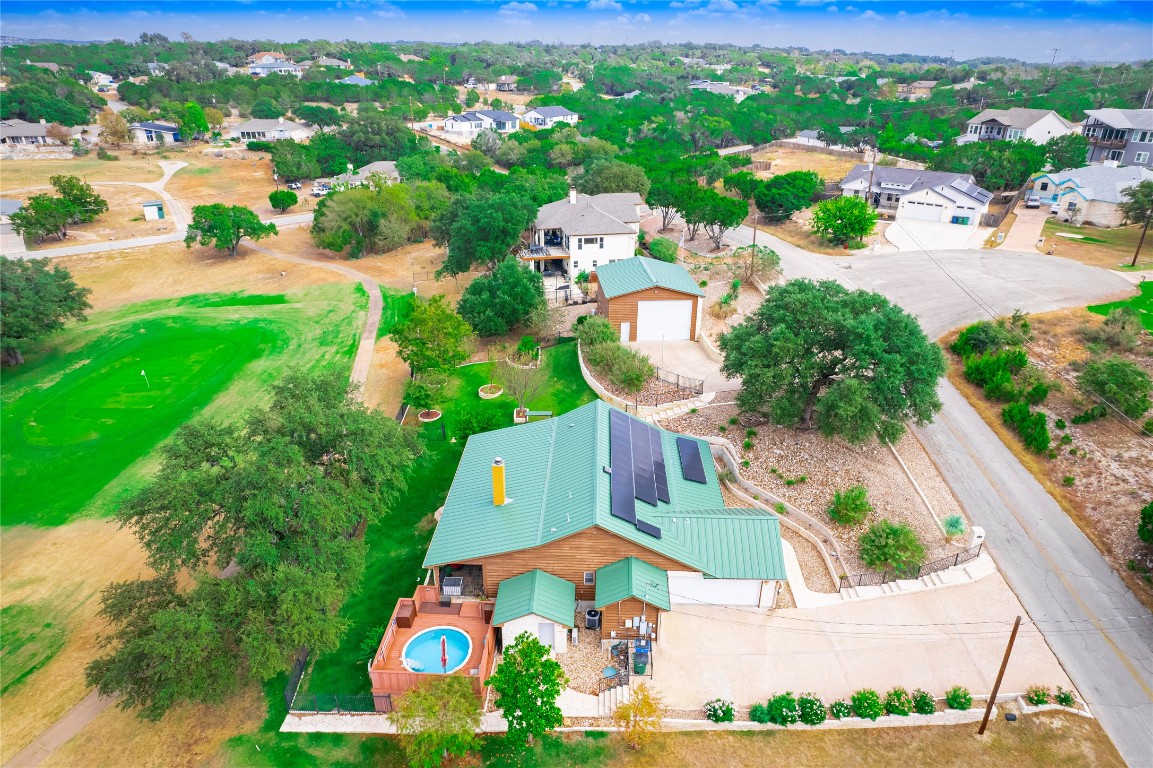 an aerial view of residential houses with outdoor space and swimming pool