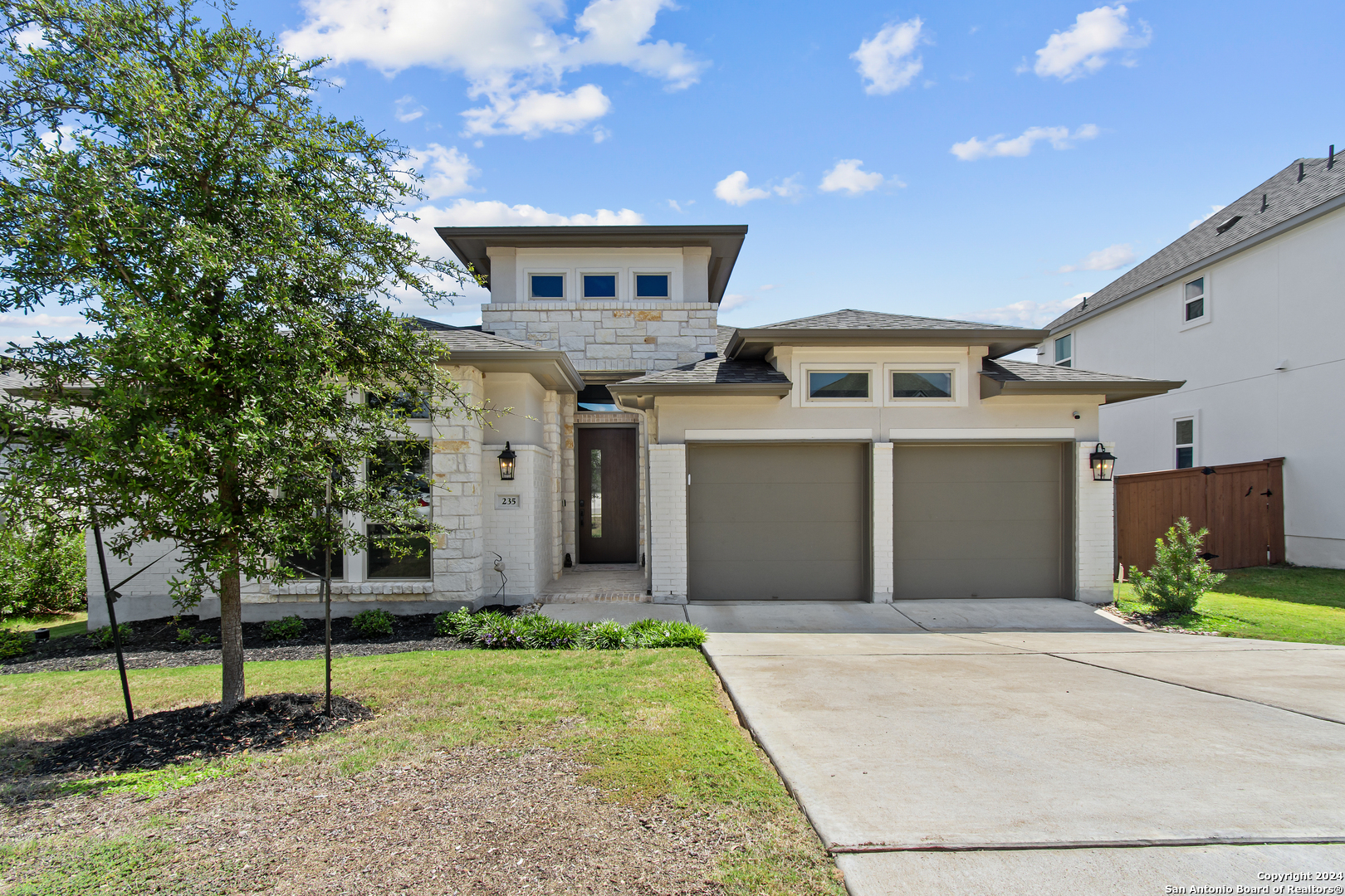 a front view of a house with garden