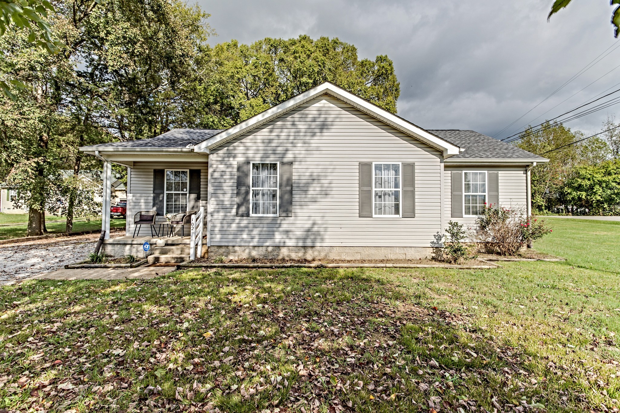 a front view of house with a garden