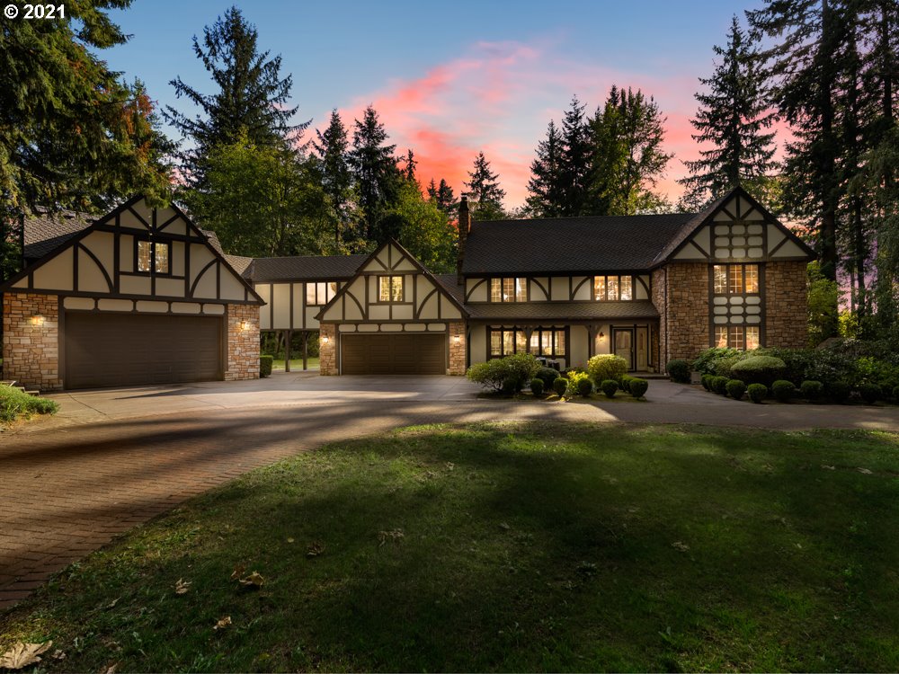 a front view of a house with yard and green space