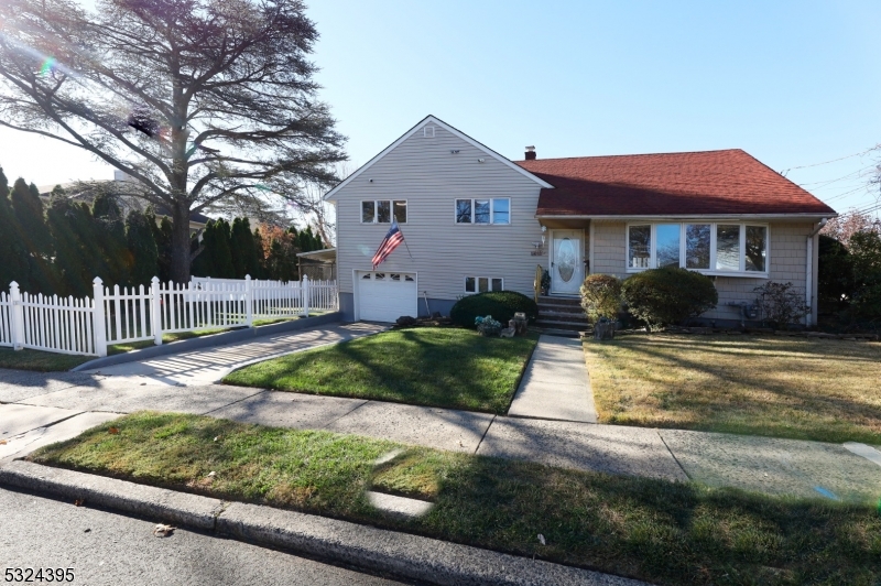 a front view of a house with a yard and table and chairs