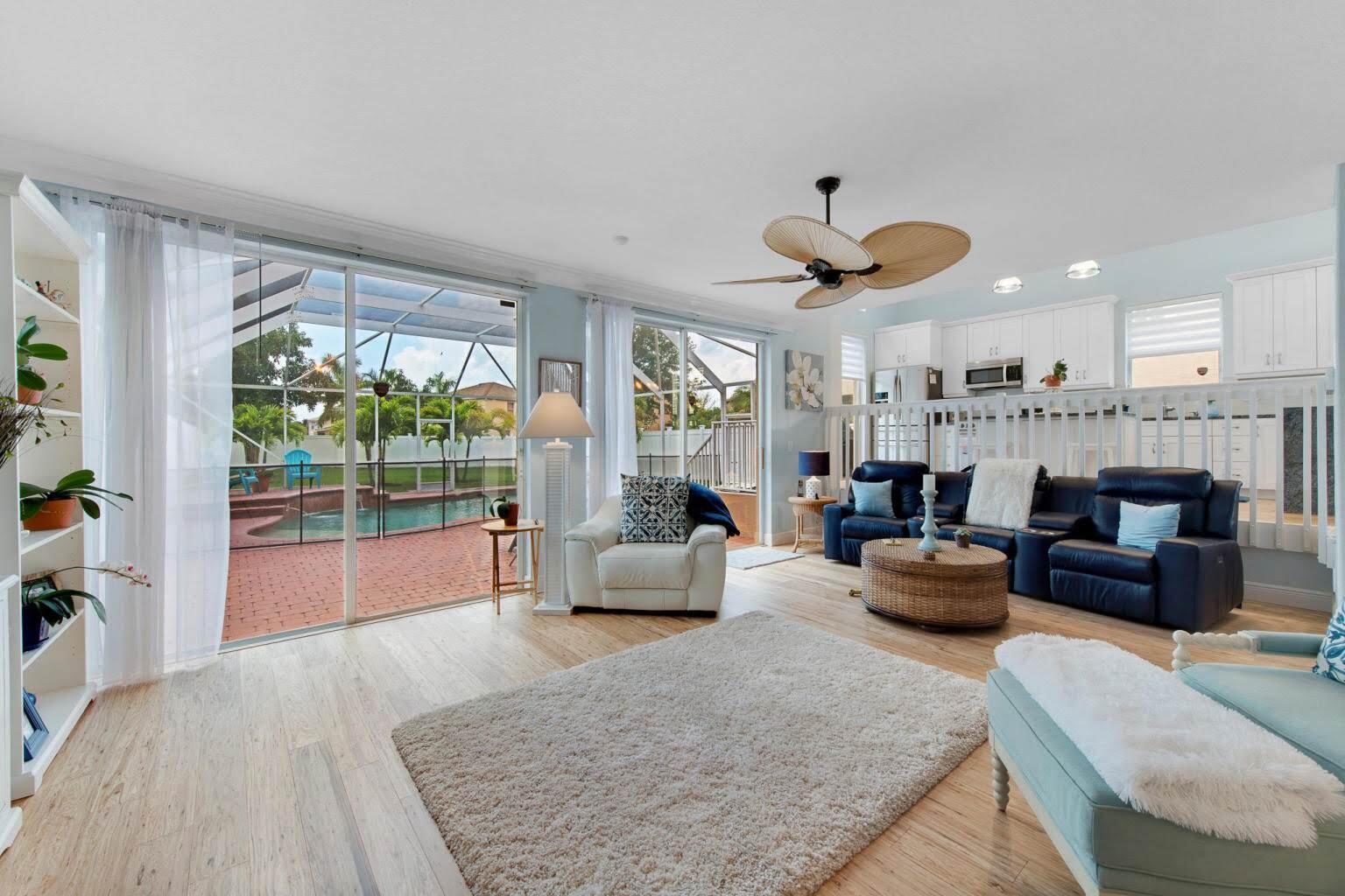 a living room with furniture a fireplace and a large window