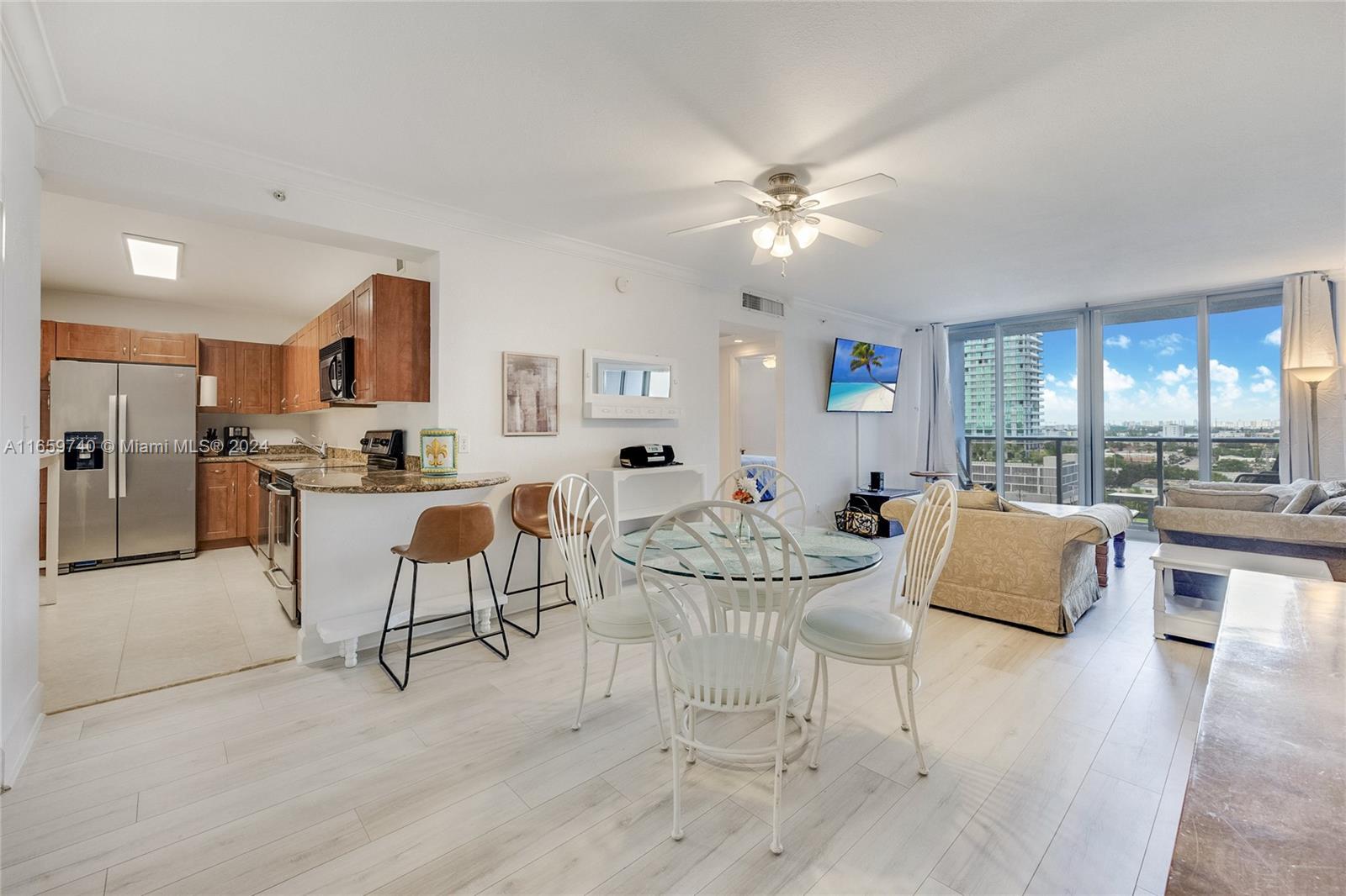 a living room with furniture and kitchen view