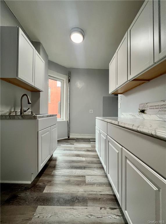 a kitchen with sink cabinets and window